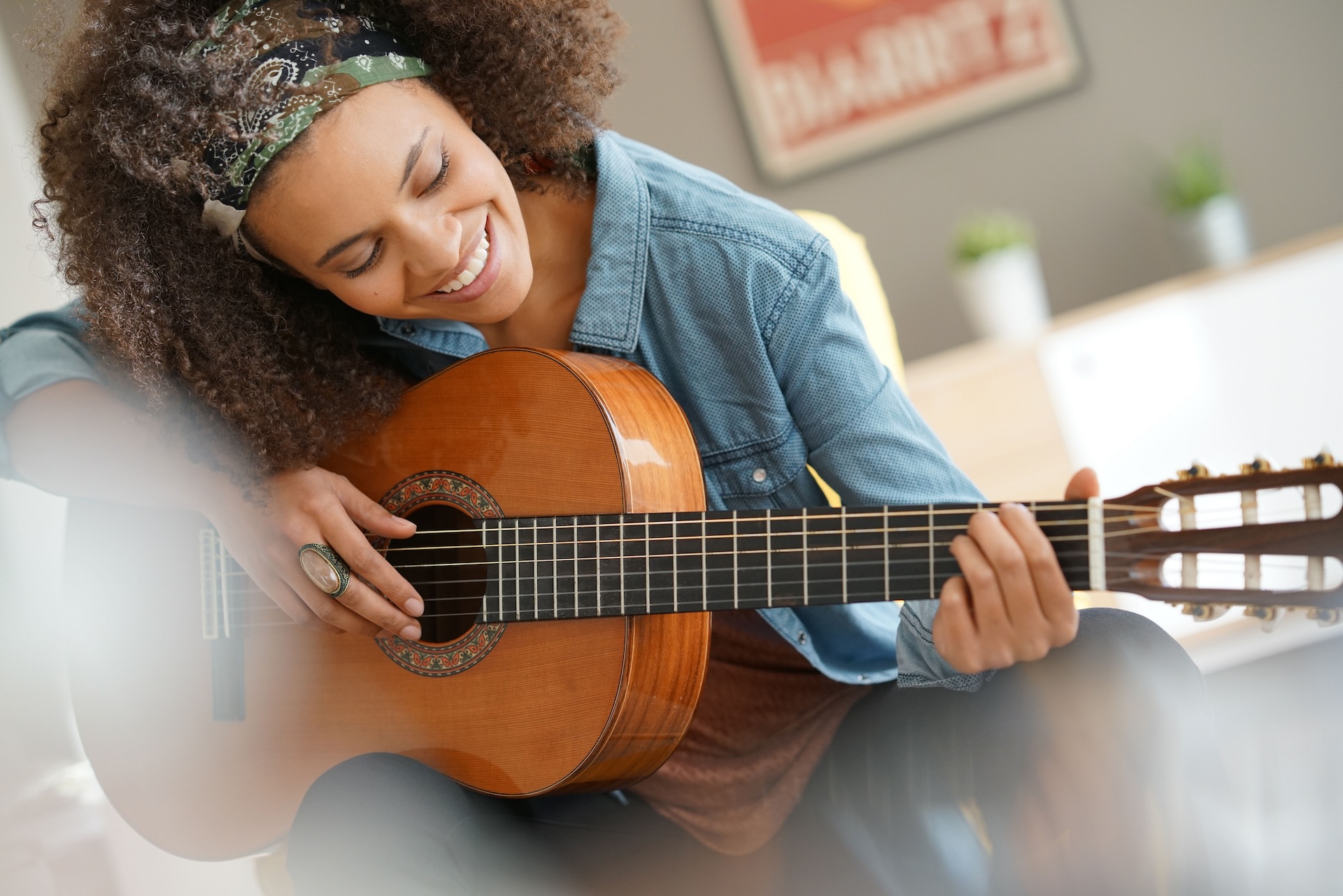 Cheerful girl playing the guitar